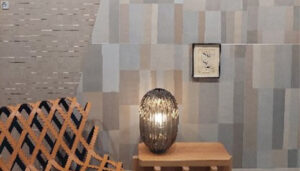 Una pared con recubrimiento de cerámica en tonos tierra, creado con tecnología inkjet